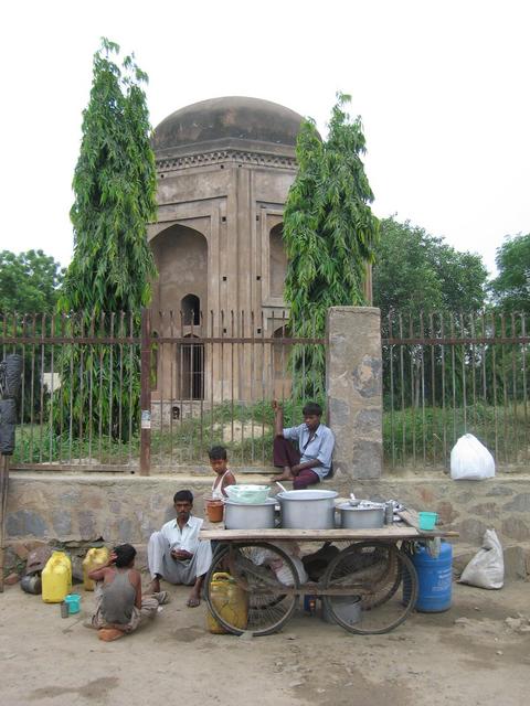 Some people relaxing outside the Tomb of Paik