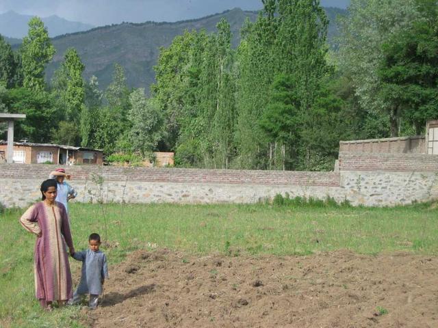 The Shah family looks on, puzzled, from a safe distance