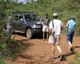 #10: Back on the roadway, Bob Buzzard greets the returning confluence hunters