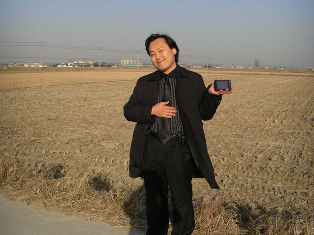 Wesley holds up the GPS navigation unit near the spot