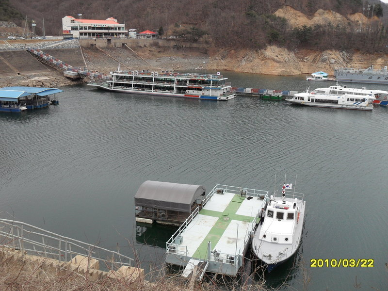 Police patrol boat in the foreground, tourist ferry docked in the far side