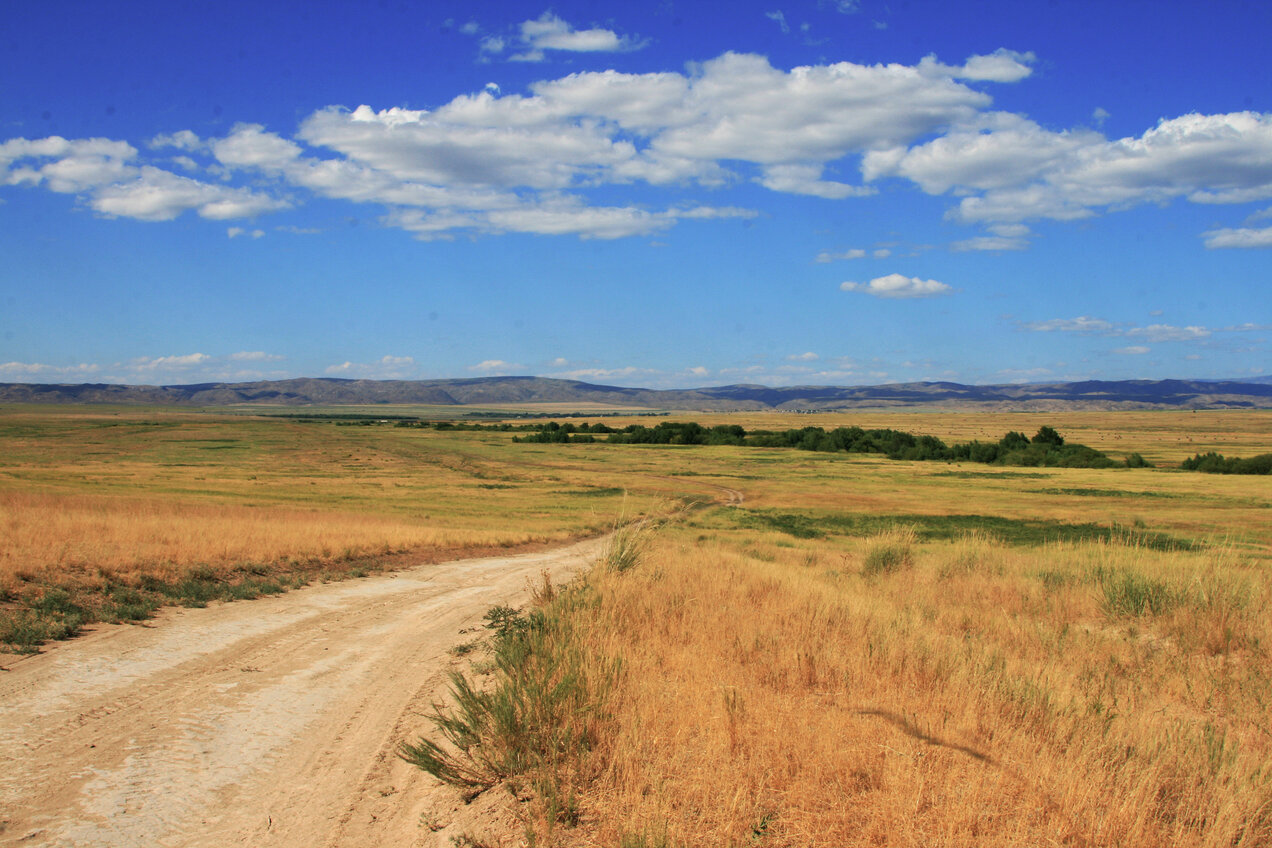 driving down a small terrain step towards Aitbay