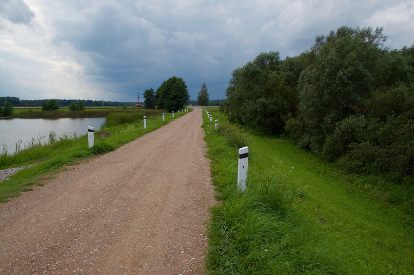 View West (along the top of the earthen dam, towards the paved road, about 150 m away)