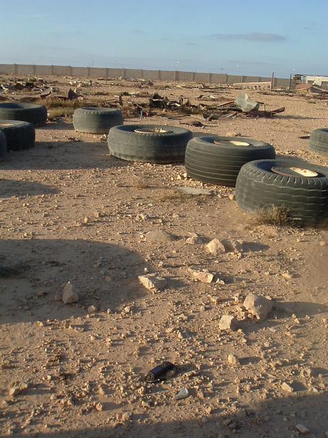 Looking north from site over debris towards compound wall