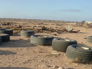 #1: Looking north from site over debris towards compound wall