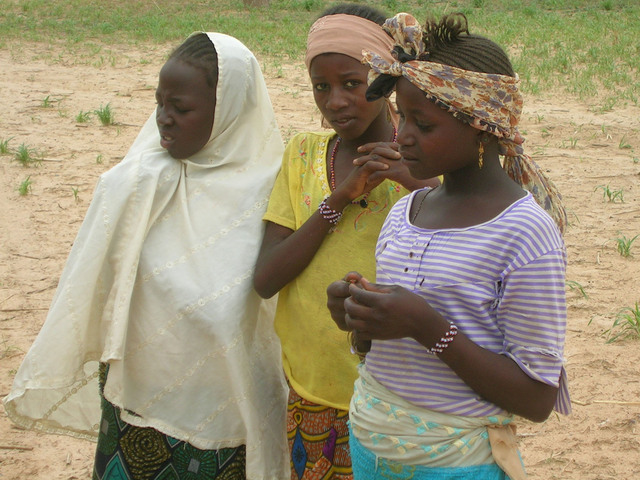 Hausa girls stop to contemplate the curious visitors