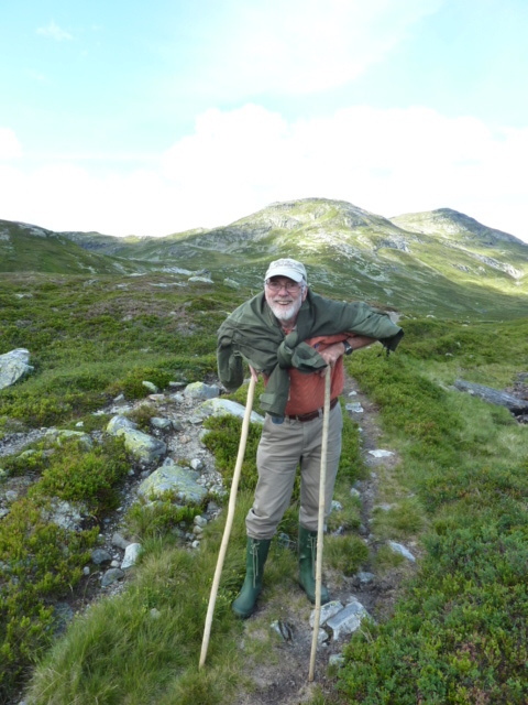 The old man with his back ache and supporting sticks