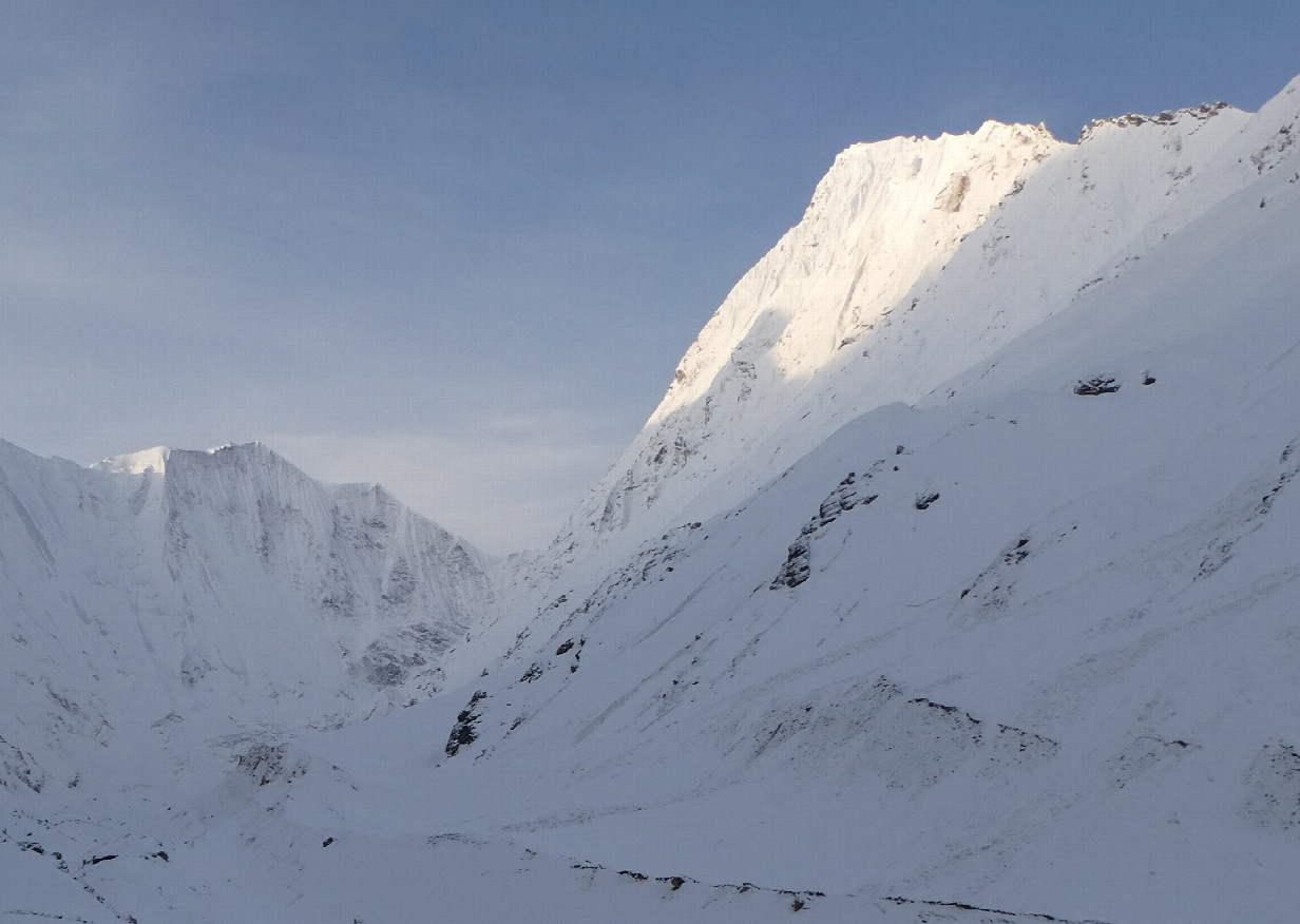 View from closest point: Mt. Nampa in sunlight, confluence halfway on the ridge