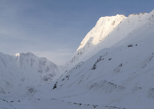 #1: View from closest point: Mt. Nampa in sunlight, confluence halfway on the ridge