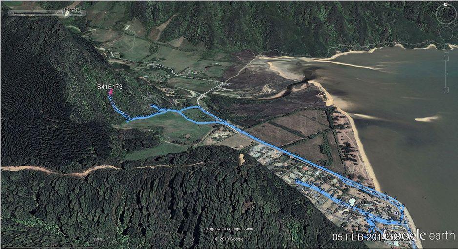 Perspective view of confluence, Sandy Beach, and Abel Tasman park in the distance, with hiking tracks between the campsite and the confluence