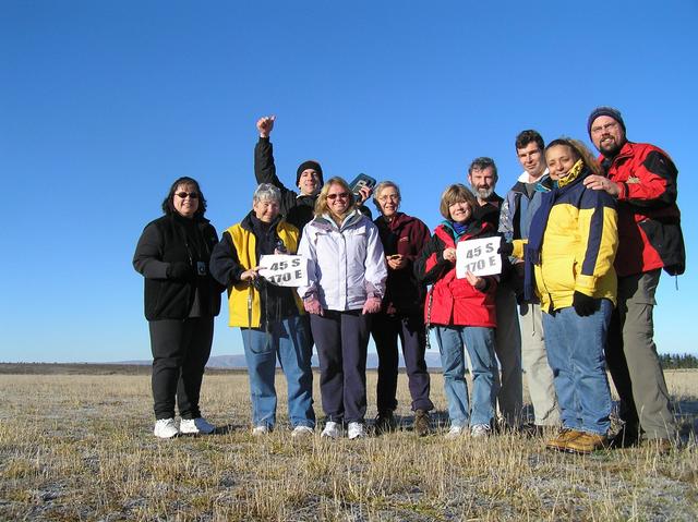 Mireya Armesto, Dorleen Jenson, Joseph Kerski, Stephanie Eddy, Anne Olsen, Margaret Chernosky, Murray Ellis, Mike Anderson, Anita Palmer, and Roger Palmer celebrate standing halfway to the South Pole.