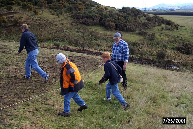 Mr. Collie holds down one of many electric fence lines so we can scamper across.