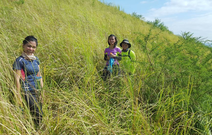 Confluence hunters mostly hidden in the very long grass