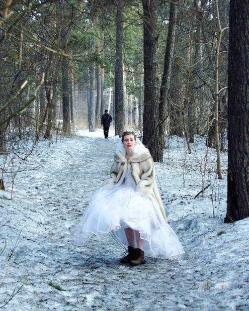 My young wife in the snow-covered park