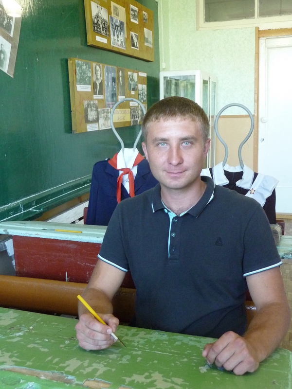 Only face-on photo of our driver Evgeny acting like a classroom student in the museum of Zuyevka history