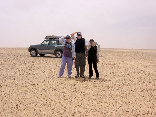 The South view of group holding hats in the strong winds