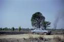 #5: Parking spot in fields; smoke from buring field in distance