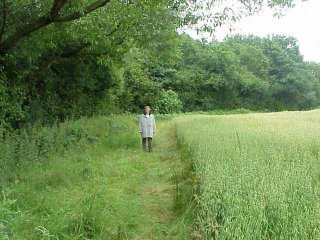 #1: Jane in the wheat field with the confluence just behind her.