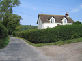 #4: View West towards Farm House - bi-directional road at left (not a driveway) - Roads are Narrow in the UK!