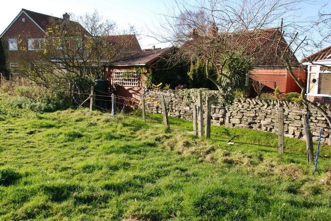 Nearby house behind the field