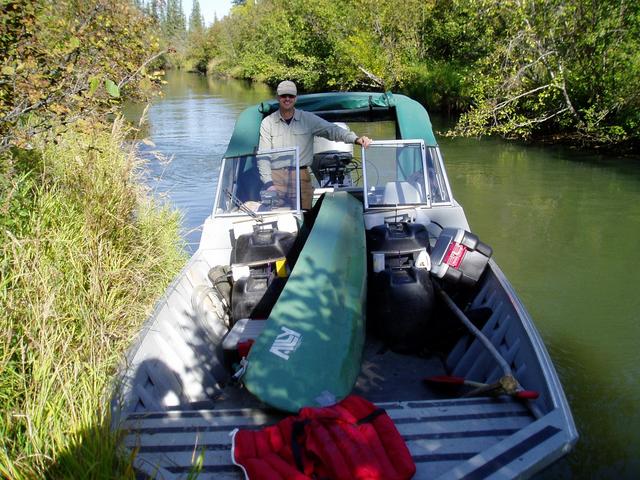 John with his boats on the creek.