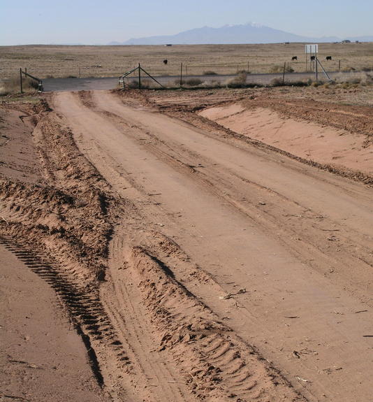 The turn-off onto a freshly bladed dirt road from Highway 264, with San Francisco Peaks visible to the southwest