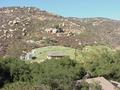 #7: Confluence site from the nearest road.  The confluence is uphill from the new guest house in the center of the photograph.