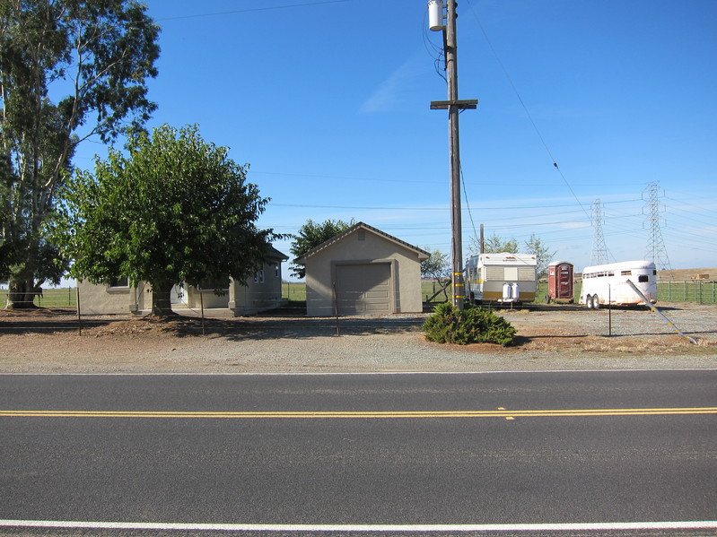 View looking west, towards the garage next to the empty house