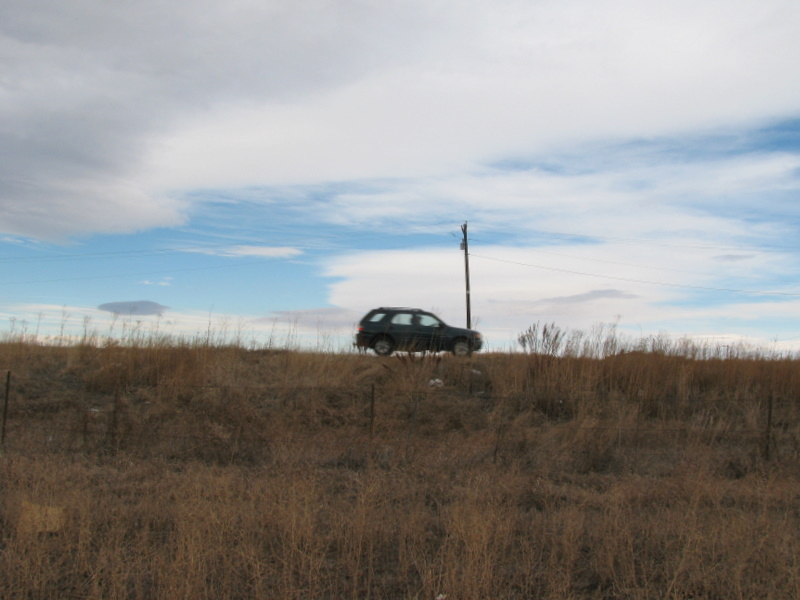 North with car passing on Baseline Road