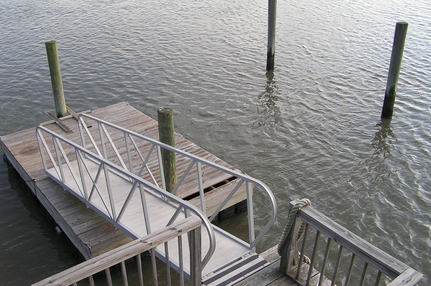 View of the confluence from above.  The confluence is just to the right (west) a few meters beyond the farthest pole in the water.