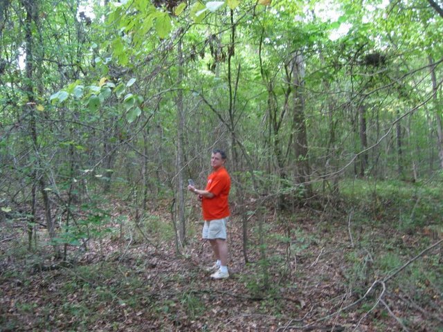 Me standing on the Confluence with the GPS dead on.