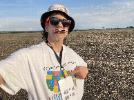 #3: Joseph Kerski at the confluence point pointing at Iowa on his map shirt. 