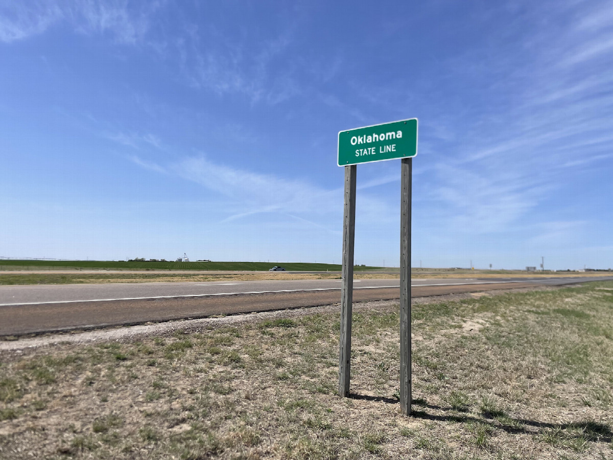 That time I took a pic of an unremarkable state border sign to make it look like that's why I was there to the passing cars. You can see Walter's truck in the background.