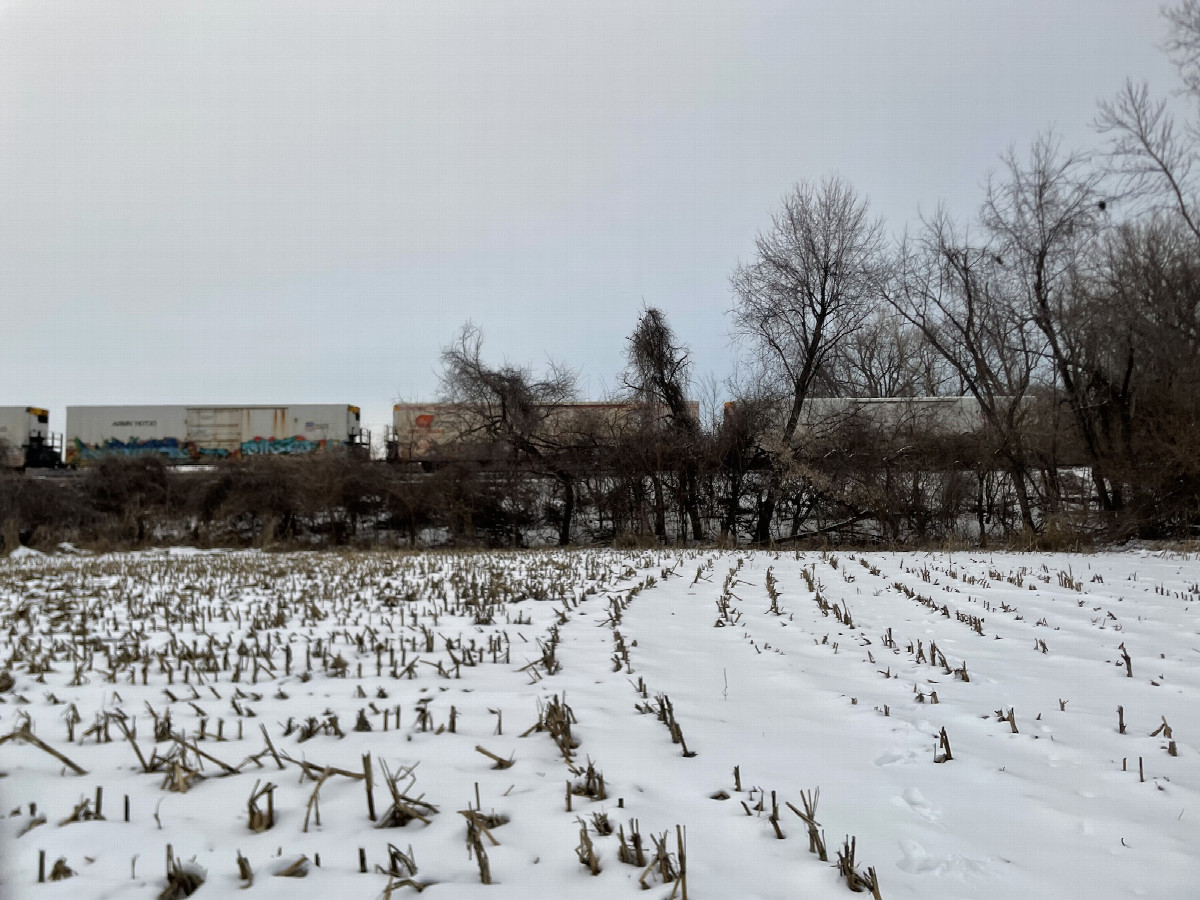 Looking back northward at train passing westward, en route to confluence