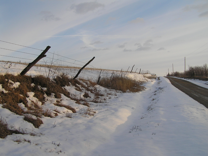 Nearest road to the confluence, the one to the west, looking south.