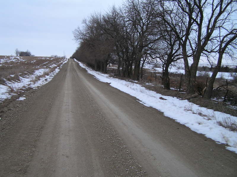 Nearest road to the confluence, the one to the west, looking south.