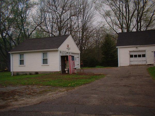 Outhouse, enshrouded in original American flag and topped by Old Dixie.