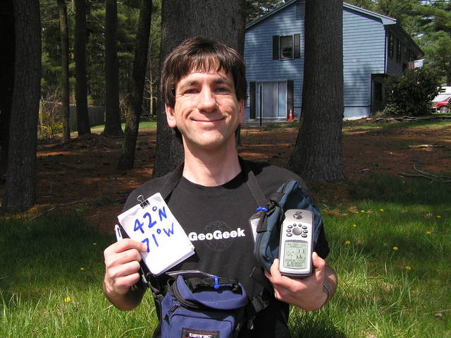 Joseph Kerski sitting on the stone wall a few meters north of the confluence in his GeoGeek shirt.