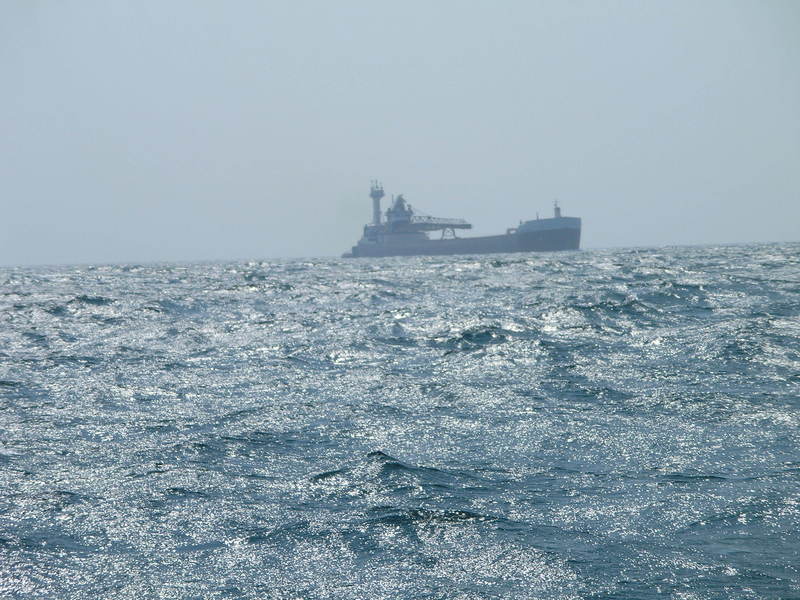 A ship crosses our stern as we approach Ludington, Michigan.