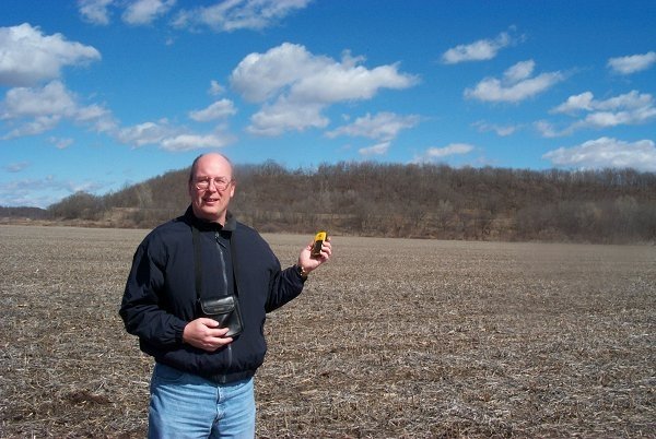 North view from confluence and Larry Lyday holding Etrex