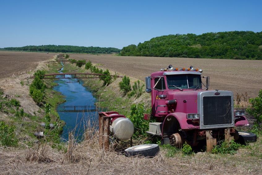 The engine of this truck is apparently being used to run a pump for this irrigation canal