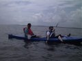 #5: Laurie and Jason, low in the water and with the sun and southern shore behind them.