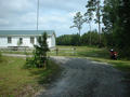 #6: This is (I think) the closest house to the confluence, about 3/4 mile away, with my motorcycle to the right.