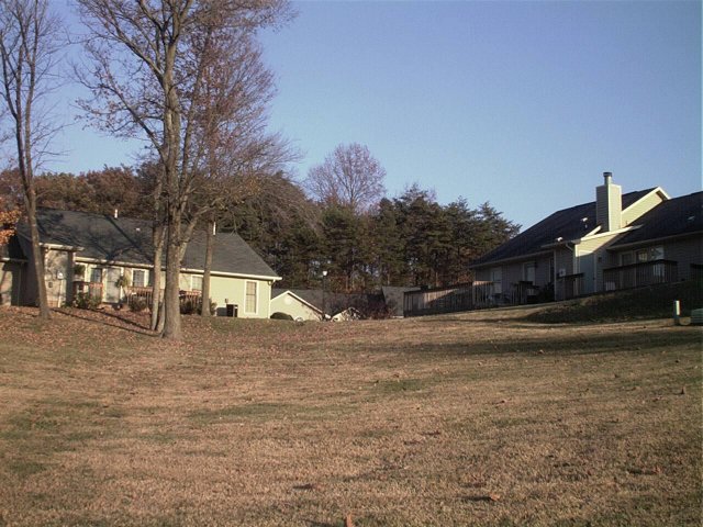 Up the hill, facing the apartments.