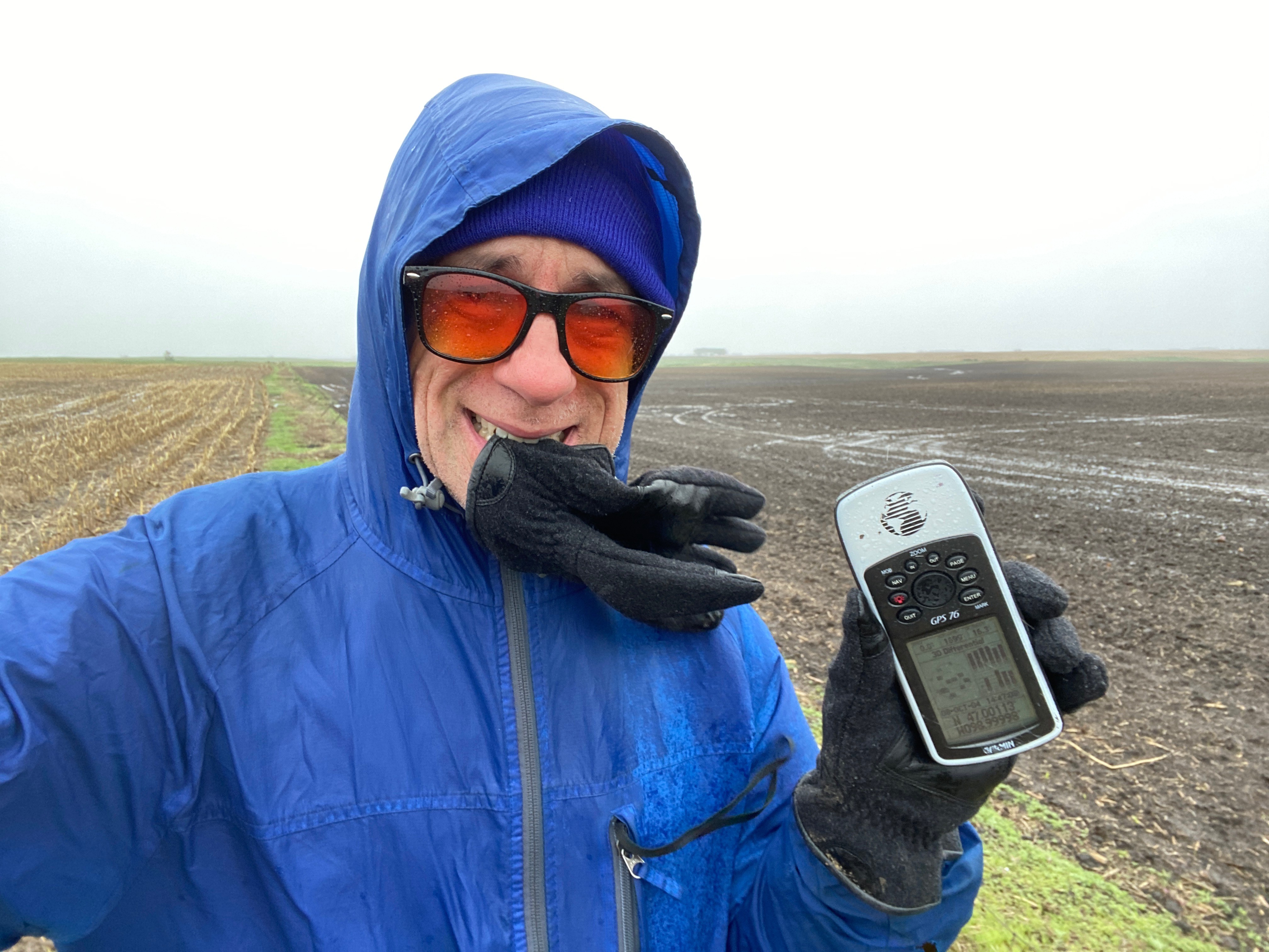 Joseph Kerski biting glove to prevent it blowing away at the confluence point. 