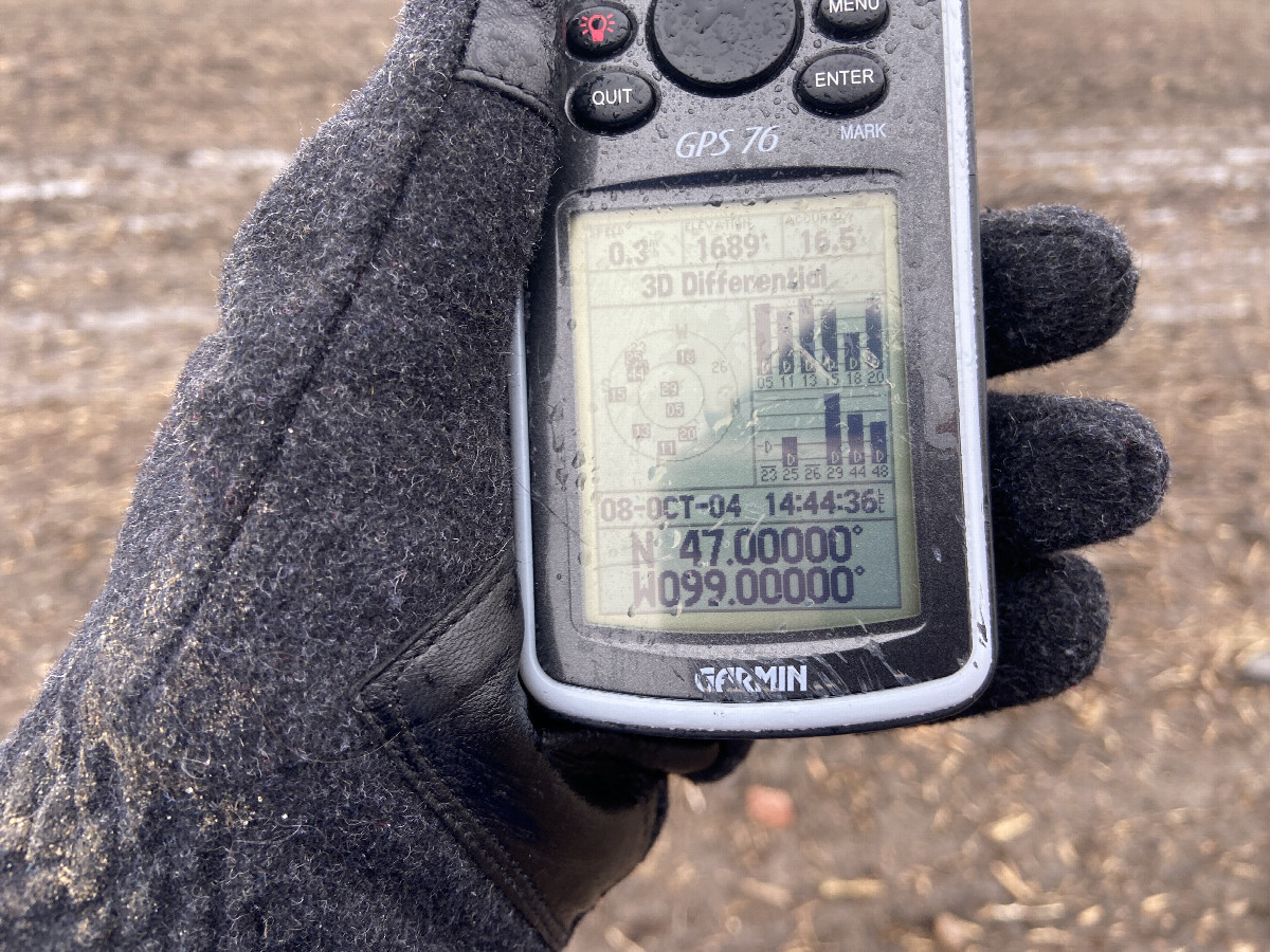 GPS unit with my frozen hand at the confluence point. 