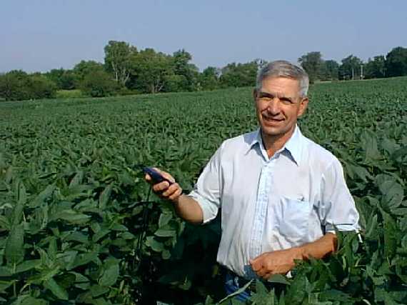 The farmer proudly holding my GPS for the photo