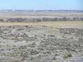 #7: View to the northeast from the top of the hill that the confluence sits on, showing the community of Alliance, Nebraska.  The line of trees in the mid-distance indicates the starting point for the hike.