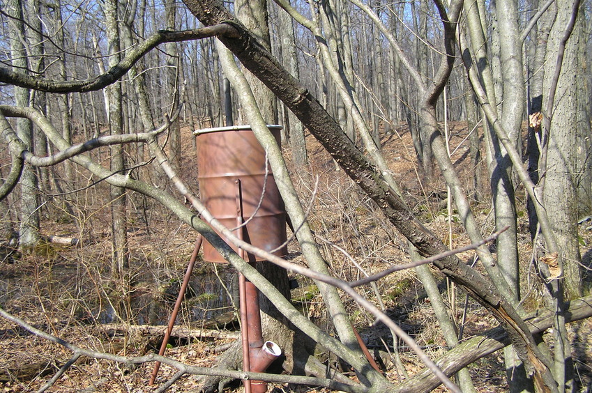 View to the west-northwest from the confluence, showing the barrel mounted almost on top of the confluence point.