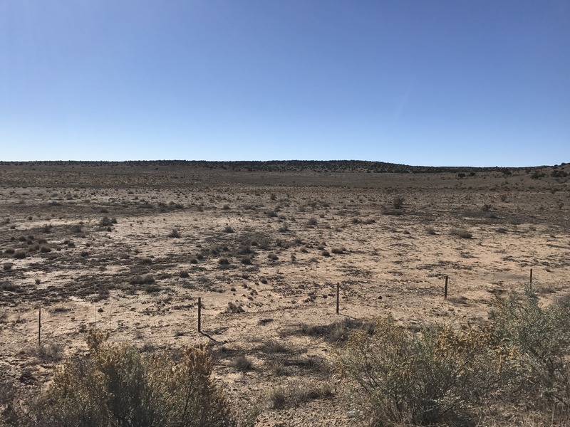 The confluence point from the I-40 frontage road - it lies beyond the low rise on the horizon. 